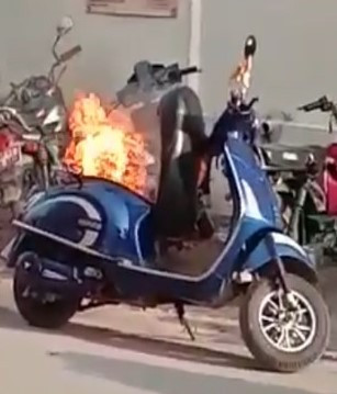 A file photo of electric two-wheeler on fire on street.
