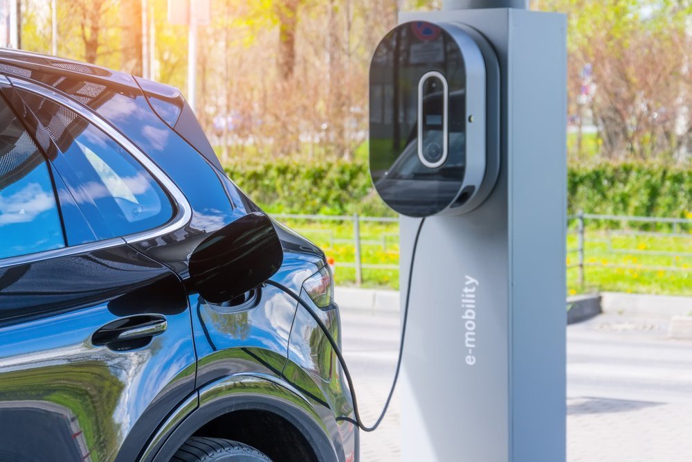 A stock photo of electric car getting charged.